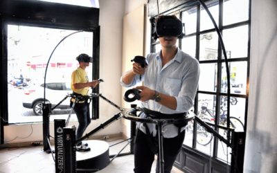 A photo showing people using VR headsets and VR locomotion hardware